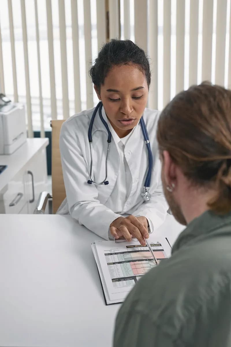 A doctor reviewing notes with a patient